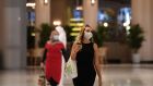 Women wearing masks  in the Mall of Dubai on  Tuesday. The shopping centre has been reopened as part of moves in the Gulf emirate to ease lockdown restrictions imposed last month to prevent the spread of  Covid-19. Photograph: Karim Sahib/AFP via Getty Images