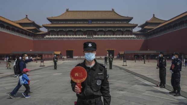 A guard at the entrance to a newly reopened Forbidden City in Beijing. Photograph: Kevin Frayer/Getty
