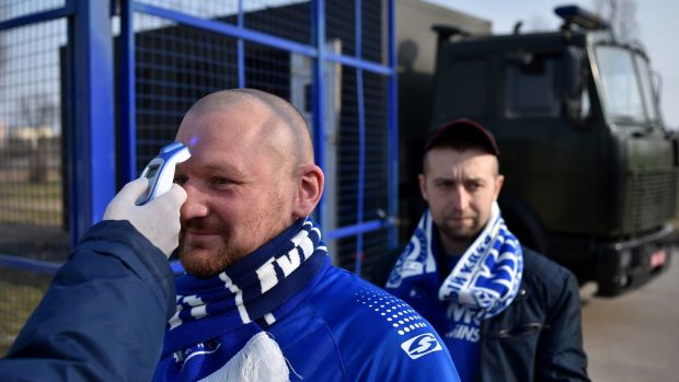A fan’s temperature is checked entering the stadium for FC Minsk v FC Dinamo-Minsk in Belarus. The Belarussian League is the only league in Europe to continue during the pandemic. Photograph: Sergei Gapon/Getty Images