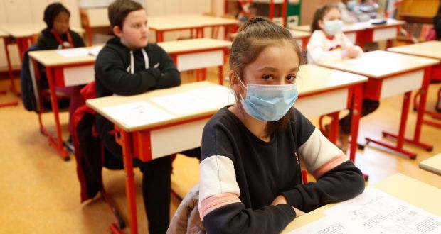 Schoolchildren, some wearing masks, attend a class in a school of Strasbourg,  France on Thursday. Photograph:Jean-Francois Badias/AP