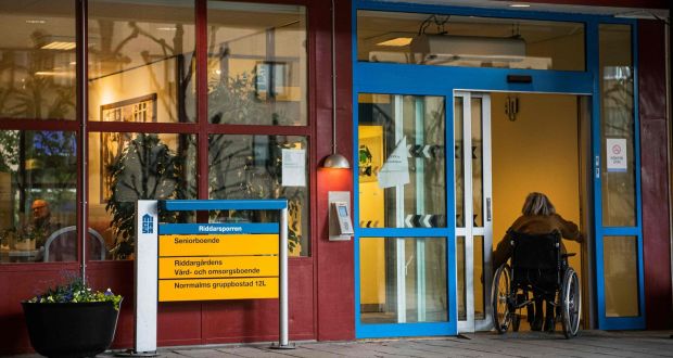 A woman enters her nursing home in Stockholm, Sweden, during the Covid-19 pandemic. File photograph: Jonathan Nackstrand/AFP via Getty Images