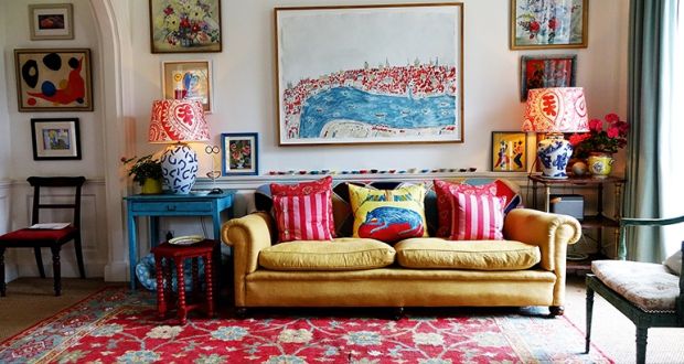 The television room is a comfortable and cosy space. The contents of the room are a real junk shop mix with a lot of the furniture found at car boot sales. The Persian rug is the anchor for the room and everything fits together around it. Photograph: by Christopher Simon Sykes.