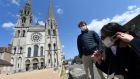 Two worshippers, Guillaume and Cynthia,  put on their as they prepare to enter the reopened Notre Dame de Chartres cathedral in central France on May 14th. Photograph: Jean-François Monier/AFP via Getty Images
