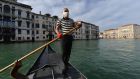 A gondolier  on a Venice canal prepares to resume service as Italy eases its cornavirus restrictions. Photograph: Andrea Pattaro/AFP via Getty Images