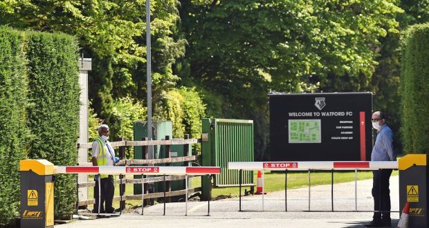 Security guards wearing PPE man a gate at Watford’s training facility at London Colney in north London. Photograph:  Glyn Kirk/AFP via Getty Images