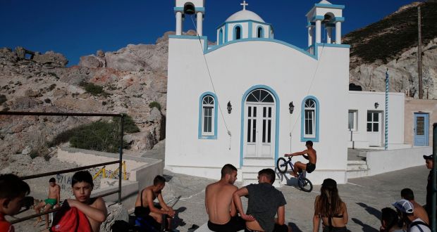Children gather in front of a Greek Orthodox church on the Aegean Sea island of Milos, Greece, on Sunday. Photograph: AP
