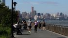 People walk along the East River on Monday, US Memorial Day, in New York. Photograph: Jason Szenes/EPA