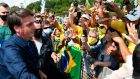 Jair Bolsonaro greets supporters in Brasília  on Sunday. Photograph:  Evaristo Sa/AFP via Getty Images