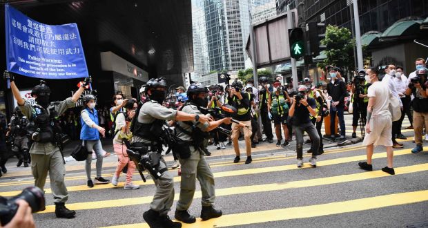  Hong Kong riot police issue a warning as they try to clear away people gathered in the Central district of Hong Kong on Wednesday. Photograph: Anthony Wallace/AFP via Getty Images