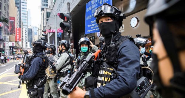 Riot police take part in a crowd dispersal operation in Hong Kong on Wednesday.  Photograph: Anthony Wallace/AFP via Getty Images