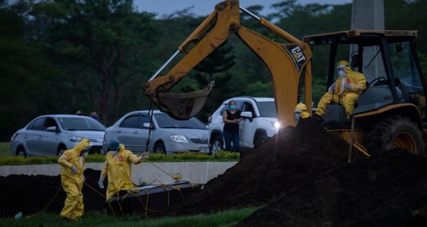 Gravediggers at Sierras de Paz cemetery in Managua, Nicaragua, on Saturday, May 30th. Nicaragua is one of the last to reject the strict measures introduced globally to curb the spread of the coronavirus and families say they are paying the price. Photograph: Inti Ocon/The New York Times