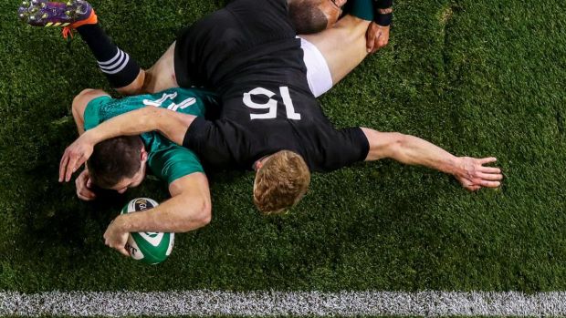 Jacob Stockdale gets over for a try despite the best attempts of Damian McKenzie and Aaron Smith of New Zealand during the November international in 2018 at the Aviva stadium. Photograph: Tommy Dickson/Inpho