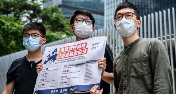 Pro-democracy party Demosisto members (L-R) Joshua Wong, Sunny Cheung and Nathan Law, hold a placard urging European leaders to act against a national security law during a press conference outside the Legislative Council in Hong Kong on Wednesday. Photograph: Antony Wallace/AFP via Getty Images
