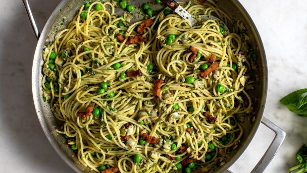 Spicy clam pasta with bacon, peas and basil