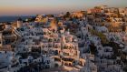 Sunset in the town of Oia on the Greek island of Santorini. Photograph: Aris Messinis/AFP via Getty Images