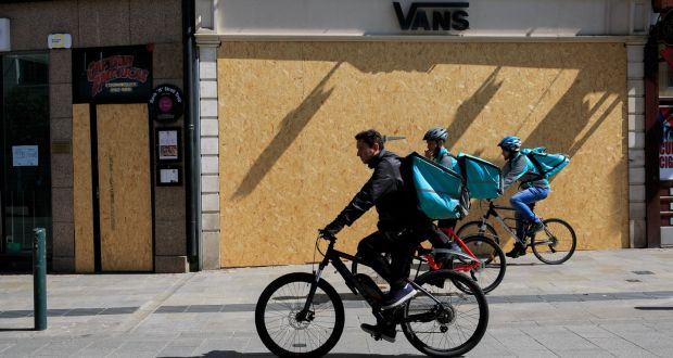 Deliveroo cyclists passing   boarded up premises  on Grafton Street, Dublin, earlier this year. Photograph: Gareth Chaney/Collins