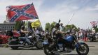 A motorcyclist flies a Confederate flag during a protest against a coronavirus stay-at-home order  in Olympia, Washington state, on May 9th. Photograph: Jason Redmond/AFP via Getty Images
