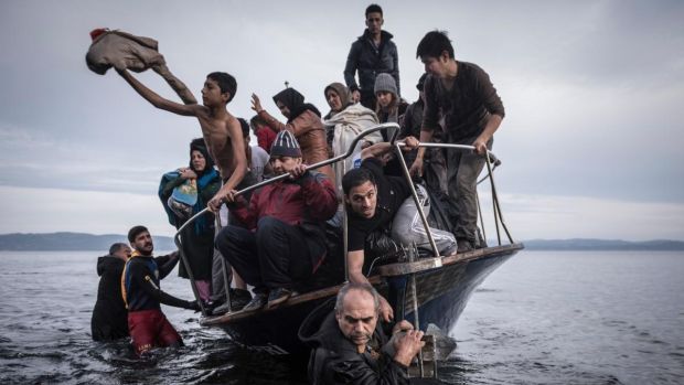 A small boat filled with migrants come ashore after making the crossing from Turkey, near the village of Skala, on Lesbos island in Greece, in November 2015. Photograph: Sergey Ponomarev/New York Times