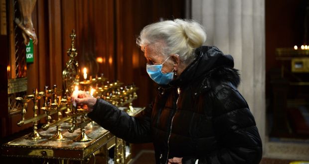 Carmel Young, lights a candle in St Mary’s Pro-Cathedral, Marlborough Street, Dublin. Photograph: Dara Mac Dónaill