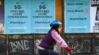 Public-service announcement posters in Melbourne counter a conspiracy theory that 5G technology causes Covid-19. Photograph: William West/AFP via Getty Images