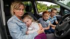 Roseanne Joyce with three of her five children – Johanna Rose, David and Danny – in the car they live in outside the offices of Tipperary County Council in Nenagh. Photograph: John D Kelly
