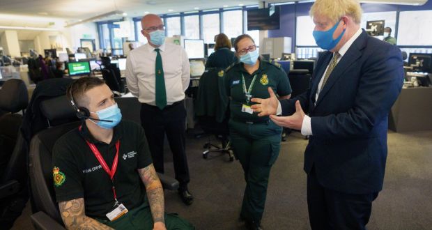 British prime minister Boris Johnson talks to paramedics during a visit to London Ambulance Service. Photograph:  Pippa Fowles
