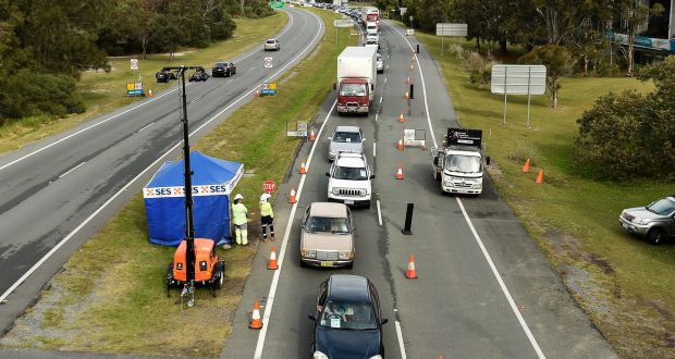 Cars wait to cross the border at Gold Coast Highway checkpoint on the Gold Coast, Australia. Photograph: Albert Perez/EPA