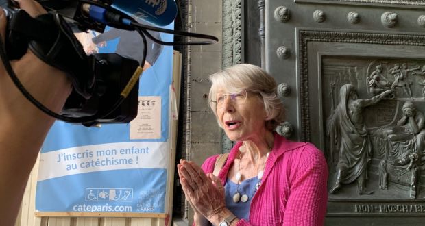 Anne Soupa being interviewed on the porch of the Église de la Madeleine. Photograph: Lara Marlowe