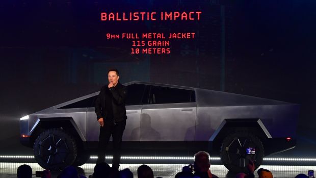 Tesla chief executive Elon Musk discusses ballistic impact in front of the newly unveiled all-electric battery-powered Tesla Cybertruck, 2019. Photograph: Frederic J Brown/AFP via Getty
