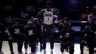  Jonathan Isaac stands as his team mates kneel before the start of a game between the Brooklyn Nets and the Orlando Magic. Photograph: Getty Images