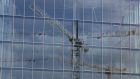 Cranes reflected against the windows of a Dublin building. Construction activity increased in July. Photograph: Nick Bradshaw/The Irish Times