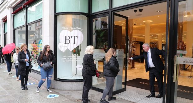 Brown Thomas managing director Donald McDonald opens the doors at the Grafton Street store on its reopening after the Covid shutdown. Photograph: Nick Bradshaw/The Irish Times 