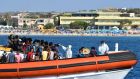 Migrants  from Tunisia and Libya are examined as they arrive on board  an Italian coast guard  boat in the Italian Pelagie Island of Lampedusa. Photograph:  Alberto Pizzoli/AFP/Getty 