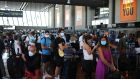 People queue in line to check in for a British Airways flight to Heathrow airport at Nice airport. Photograph: Daniel Cole/AP Photo