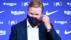 Barcelona’s new Dutch coach Ronald Koeman removes his facemask during his official presentation at the Camp Nou stadium in Barcelona on Wednesday. Photograph: Josep Lago /AFP via Getty Images)