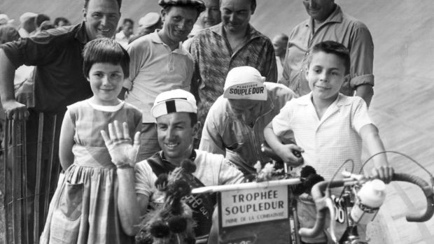Shay Elliott takes a ride in a pram after arriving in Toulouse during the 1961 Tour de France. Photograph: Keystone/Getty Images