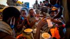 Migrants have a meal on board the SeaWatch 4 civil sea rescue ship, that is waiting for permission to run into a port, on sea between Malta and Italy. Photograph:  Thomas Lohnes/AFP via Getty Images