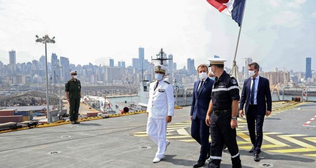 French president Emmanuel Macron  and French health minister Olivier Veran   with Arnaud Tranchant, commander of the Tonnerre helicopter carrier, off the port of Beirut. Photograph:  Stephane Lemouton/AFP/Getty  Images