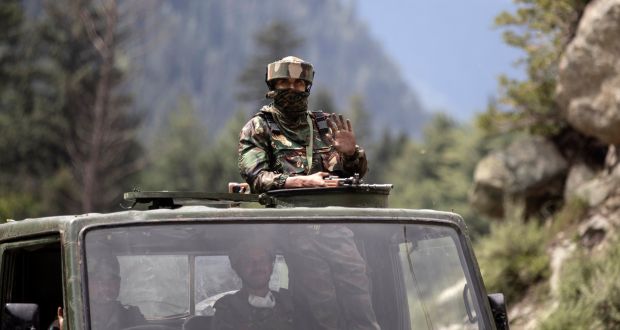 An Indian army soldier keeps guard as a convoy moves on the Srinagar-Ladakh highway at Gagangeer, northeast of Srinagar, in Indian-controlled Kashmir. Photograph: Mukhtar Khan/AP