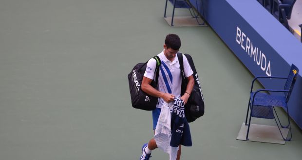 Novak Djokovic walks off the court after being defaulted due to inadvertently striking a lineswoman with a ball at the US Open. Photograph: Getty Images
