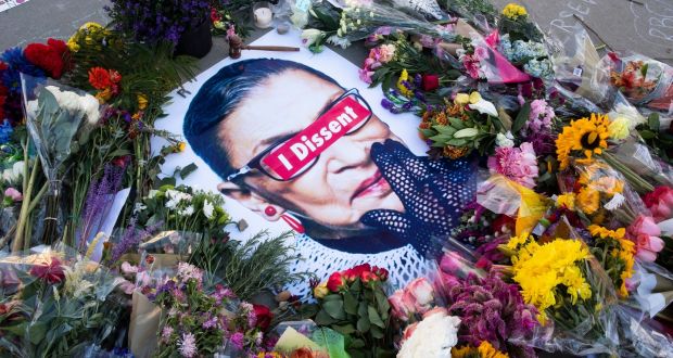  Flowers, candles and messages encircle an image of the late US justice Ruth Bader Ginsburg. It is understood her dying wish was that her successor  be appointed after the election. Photograph: Michael Reynolds