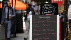 Signs advertise indoor dining on a Manhattan street as New York restaurants open their doors to 25 per cent capacity caps. Photograph: Spencer Platt/Getty 