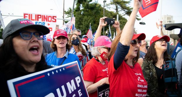 Supporters of US President Donald Trump sing the national anthem while rallying outside Walter Reed National Military Medical Center in Bethesda, Maryland. Photograph: Graeme Sloan/Bloomberg