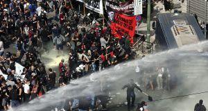 Clashes between riot police and protesters after the Golden Dawn trial verdict was announced in Athens. Photograph: Orestis Panagiotou/EPA