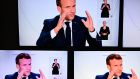 Screens display French president Emmanuel Macron addressing the nation about coronavirus in Paris on Wednesday night. Photograph: Christophe Archambault/AFP via Getty Images