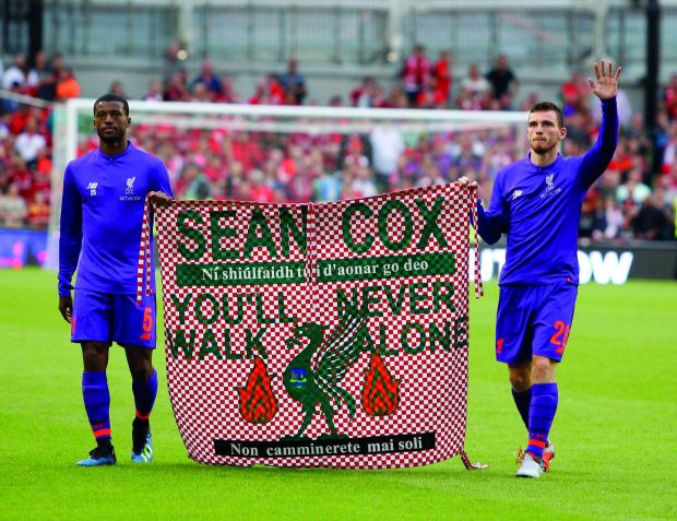 Liverpool players Gini Wijnaldum and Andy Robertson holding up Seán’s banner after Liverpool beat Napoli 5-0 at the Aviva Stadium. Photograph: Action Plus Sports/Alamy Live News