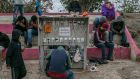 Migrants charge  phones at a temporary camp in Matamoros, Mexico, near the US border, earlier this year. File photograph: Meghan Dhaliwal/New York Times