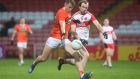 Armagh’s Oisín O’Neill shoots as Derry’s Padraig Cassidy chases him. Photo: Lorcan Doherty/Inpho