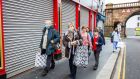 Pedestrians pass shuttered shops in Derry. The Northern Executive is to meet again on Tuesday to  discuss whether to extend the current four-week lockdown by another two weeks. Photograph: Bloomberg 