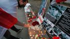 Belarusians living in Ukraine along with their supporters and Ukrainian activists lay flowers and candles at a symbolic memorial for Roman Bondarenko in Kiev. Photograph: Sergey Dolzhenko/EPA